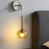 Applique cromo per comodini da letto sfera vetro ambra
